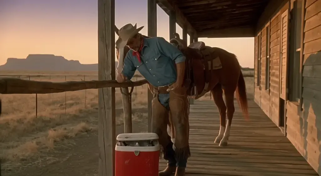 A cowboy on a ranch porch in a vintage golden-hour commercial
